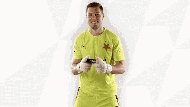 a man wearing a yellow shirt with etoro on it