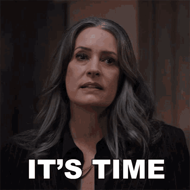 a woman with gray hair says it 's time in white letters