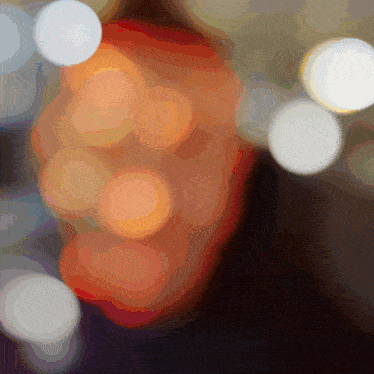 a blurred image of a person 's face with circles in the foreground
