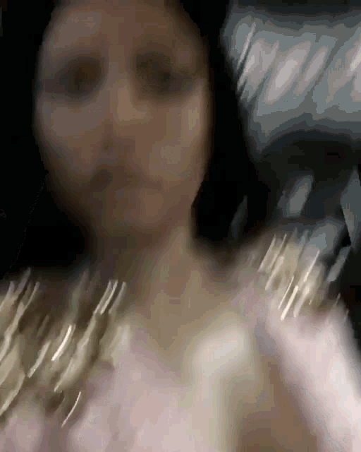 a blurry picture of a woman 's face and arms