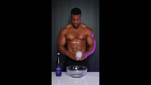 a shirtless man is pouring ice into a bowl next to a bottle of aquafina water