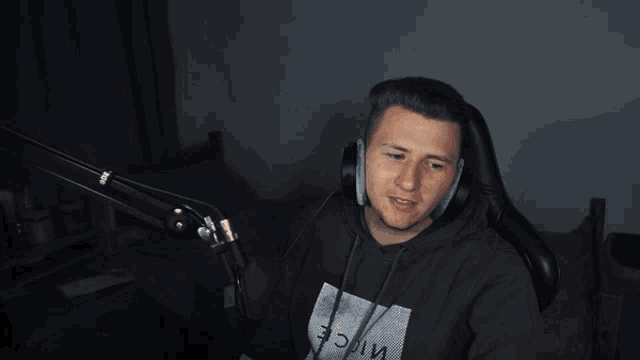 a man wearing headphones is sitting in a chair that says br mota on it