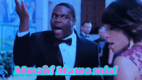a man in a tuxedo and bow tie says " mwah! mama mia "