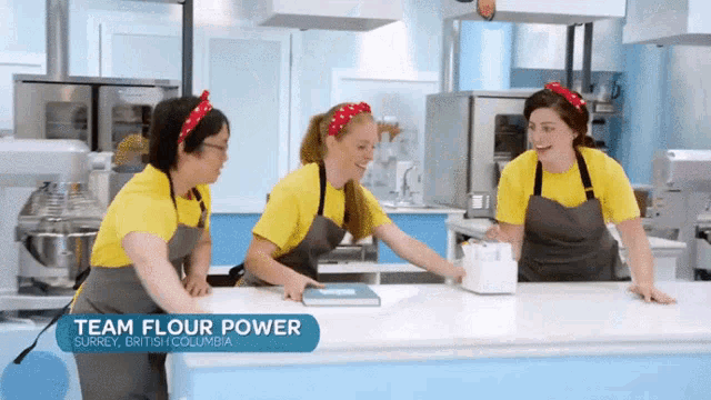 three women are working in a kitchen and they are from the team flour power in surrey british columbia