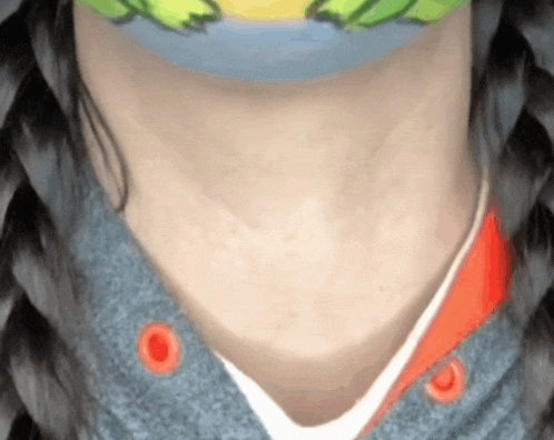 a close up of a person 's neck wearing a mask