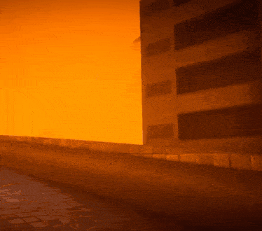 a building with a sunset in the background