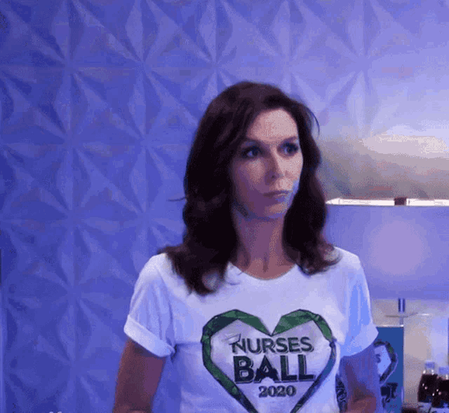 a woman is wearing a nurses ball 2020 t-shirt
