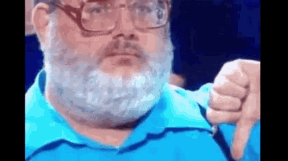 a man with a beard and glasses is giving a thumbs down gesture .