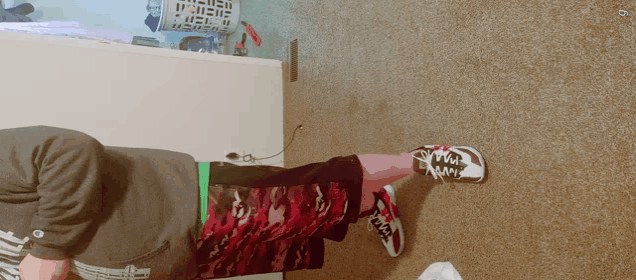 a person laying on the floor wearing a pair of shoes that say ' converse ' on them
