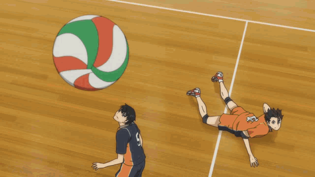a large volleyball is being thrown by a person in a gym