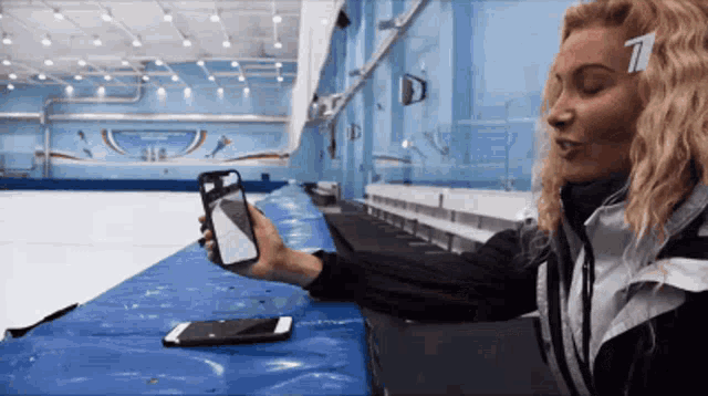 a woman is taking a picture of herself with a cell phone with the number 7 on her head