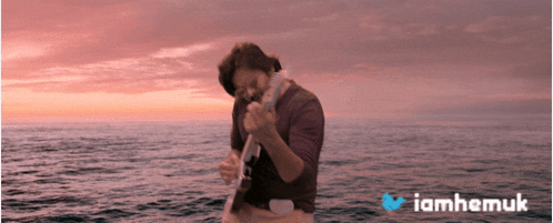 a man is standing in the middle of the ocean with iamhemuk written on the bottom of the image