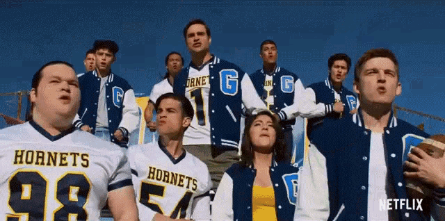 a group of hornets football players standing in a stadium