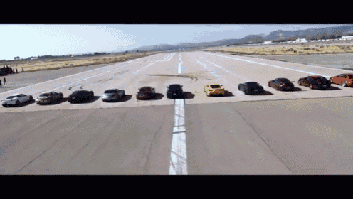 a row of cars are lined up on a road