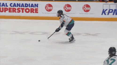 a hockey game is being played in front of a goodlife fitness banner