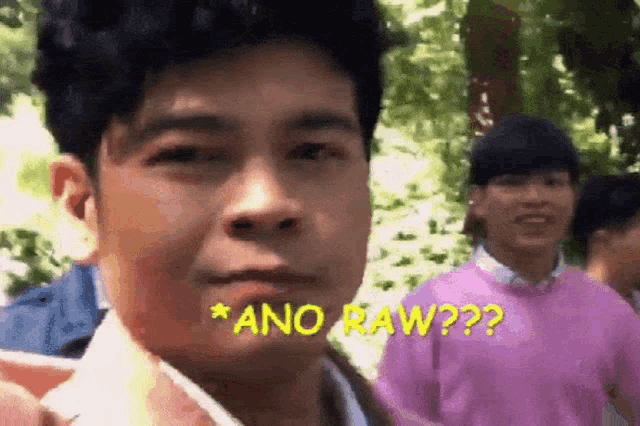 a man is making a funny face with the words ano raw written on his face