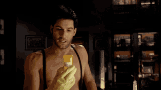 a man wearing a yellow rubber glove is drinking from a yellow cup
