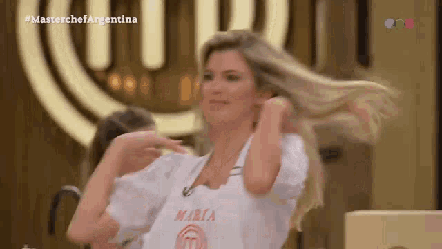 a woman is wearing a white apron that says maria