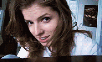 a close up of a woman 's face with a white shirt on