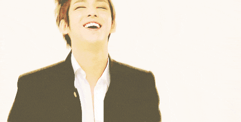 a man in a suit is making a funny face with his mouth open