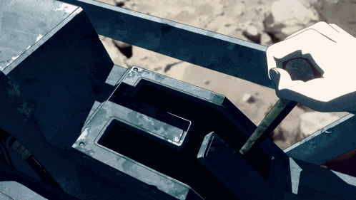 a hand is holding a coin in front of a metal letter e