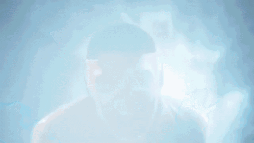 a man wearing a white mask is screaming in the dark .