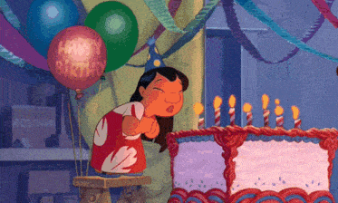 a girl blowing out candles on a birthday cake with a balloon that says happy birthday