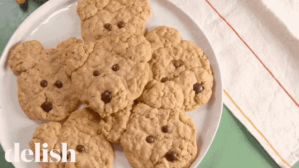 a plate of teddy bear shaped cookies with the word delish on the bottom right