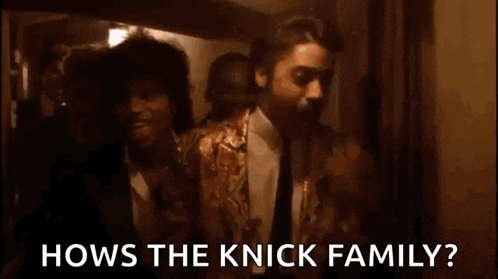a man is sitting in front of a mirror holding a candle and asking how the knick family ?