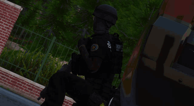 a police officer is standing in front of a brick wall and holding a gun