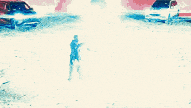 a man is standing in the snow holding a bottle