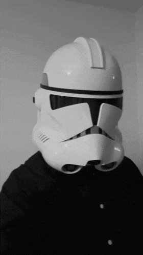 a person wearing a storm trooper helmet with a black shirt