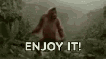 a monkey is standing in the woods with the words enjoy it written below it .