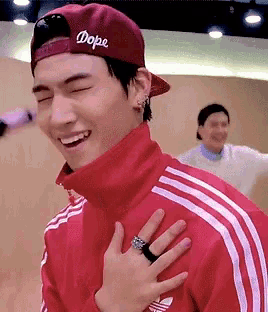 a young man wearing a red hat that says dope on it