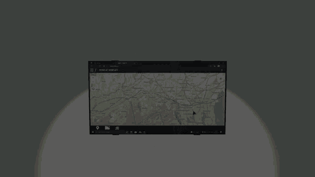 a computer monitor is floating in the air with a spotlight shining on it