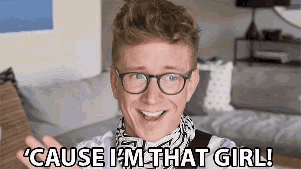 a man wearing glasses and a scarf says ' cause i 'm that girl '