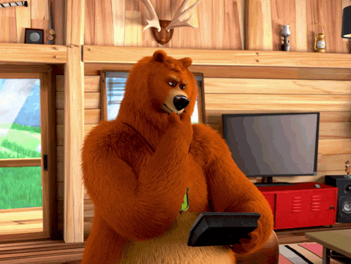 a bear holding a tablet in front of a tv
