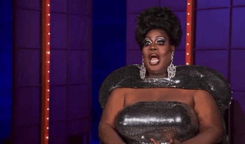 a drag queen says " crickets bitch " while wearing a sequined dress