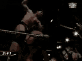a man is standing in a boxing ring with a skull in the background and the time is 3:37 .