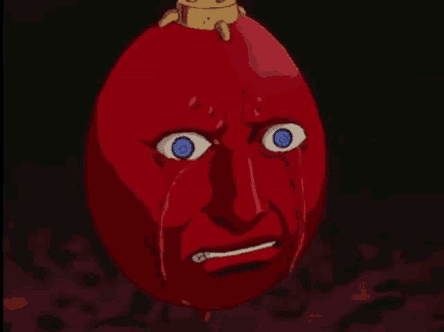 a red egg with a crying face on it .