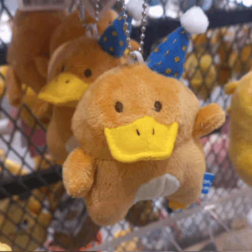 a stuffed animal that looks like a duck with a party hat on