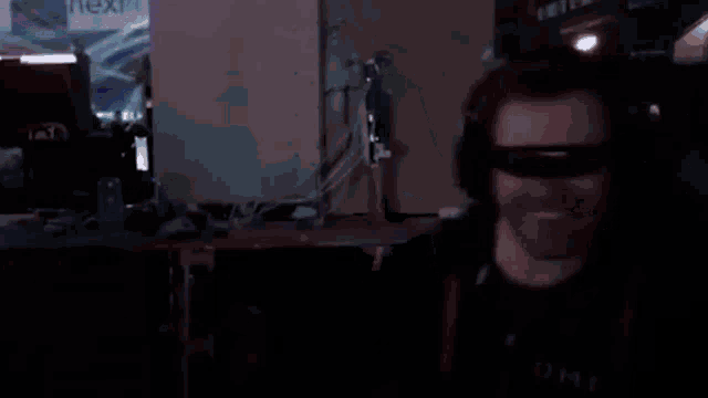 a man wearing 3d glasses and headphones is sitting in a gaming chair
