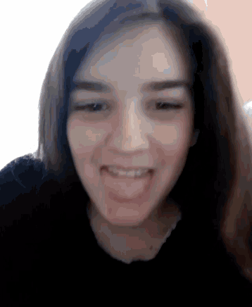 a close up of a woman making a funny face