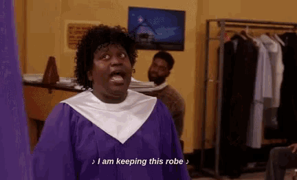 a woman in a purple gown is standing in front of a rack of clothes and talking about keeping this robe .