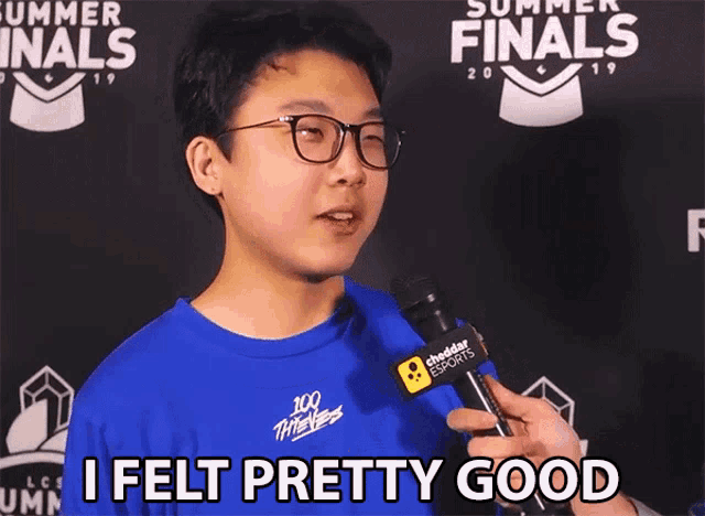 a young man wearing glasses and a blue shirt is holding a microphone and says i felt pretty good