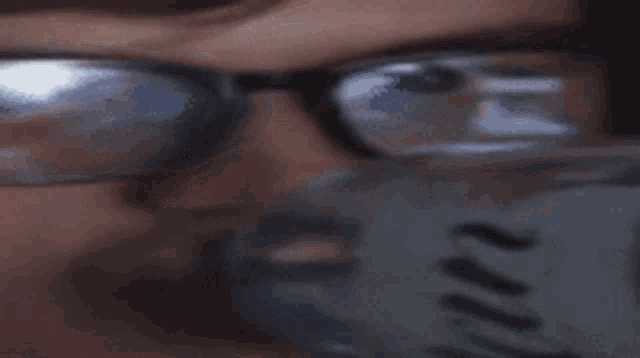 a close up of a person wearing glasses