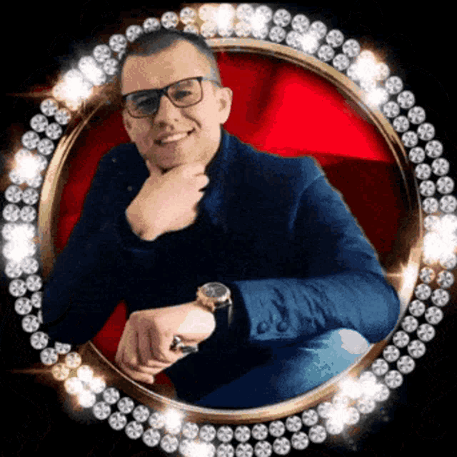 a man wearing glasses and a watch is sitting in a circle of diamonds