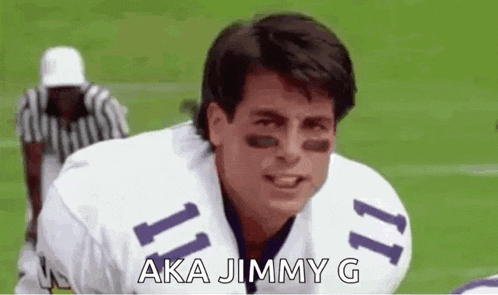 a football player in a white and purple uniform is kneeling on the field .