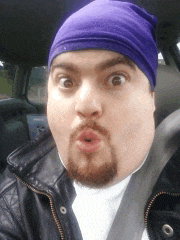 a man wearing a purple beanie is making a funny face in a car