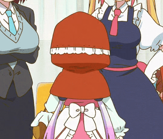 a girl with a red hood and a bow on her dress is standing next to two other girls